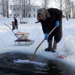russian woman washing clothes in river
